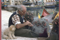 Sanddancers on Holiday, Malta fisherman mending nets